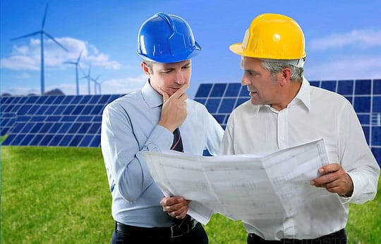 architect engineer two expertise team plan talking hardhat solar plates meadow grass